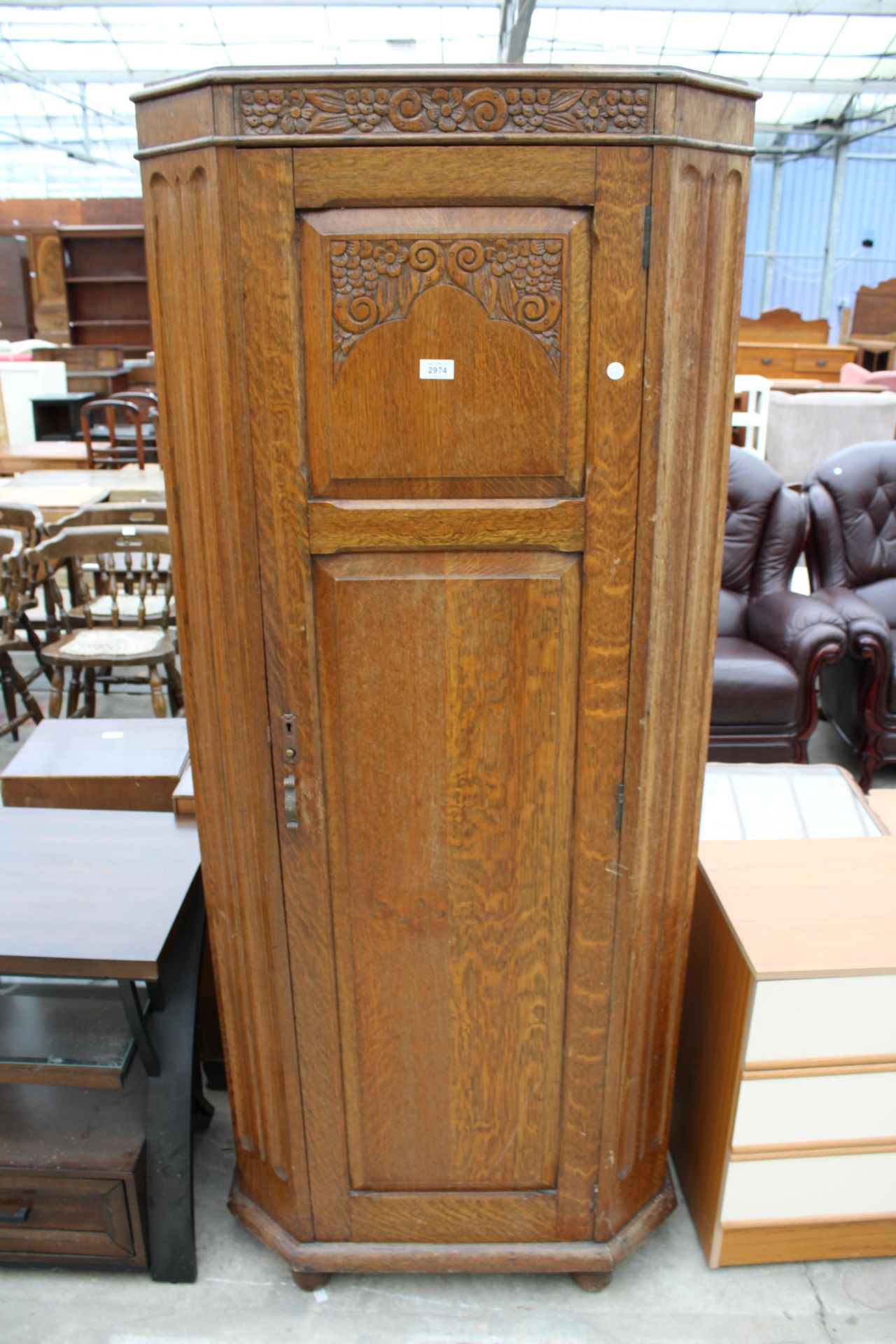 AN EARLY 20TH CENTURY OAK HALL WARDROBE WITH CARVED PANEL DOOR 30" WIDE