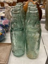 EIGHT GLASS CODD BOTTLES, WITH ADVERTISING TO THE FRONT AND GLASS MARBLE STOPPERS