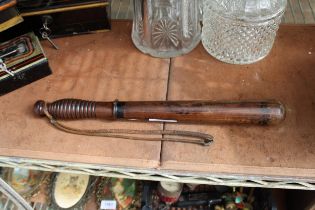 A VINTAGE WOODEN POLICE TRUNCHEON