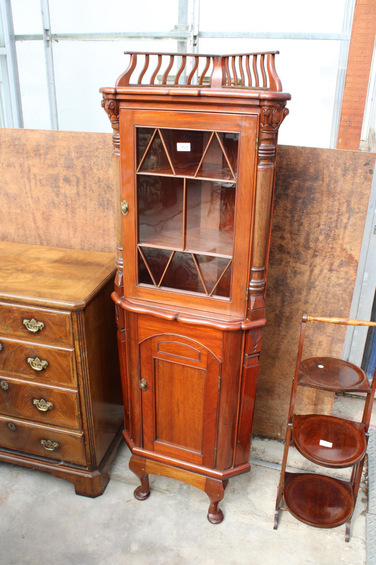 A 19TH CENTURY STYLE MAHOGANY GLAZED CORNER CUPBOARD WITH GALLERIED TOP, THE BASE ENCLOSING PULL OUT