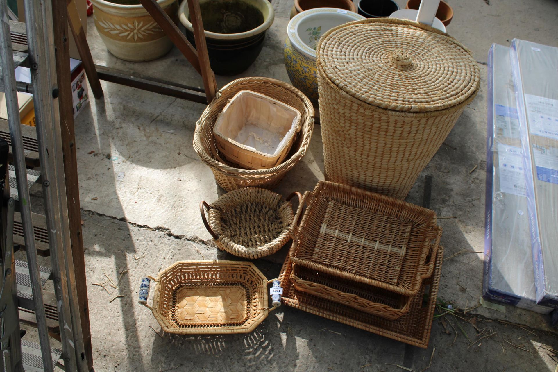 AN ASSORTMENT OF WICKER BASKETS TO INCLUDE A LAUNDRY BASKET, A TRUG AND TRAYS ETC