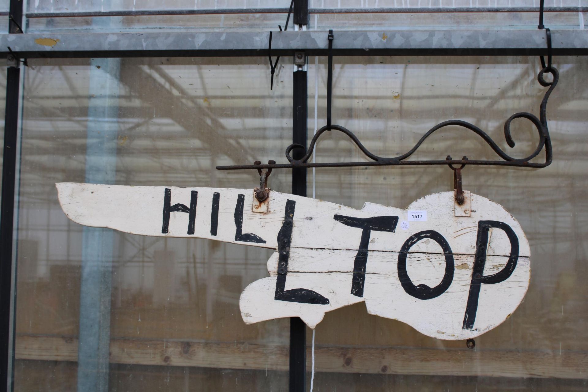 A VINTAGE WOODEN HAND PAINTED 'HILLTIOP' SIGN WITH CAST IRON HANGING BRACKET