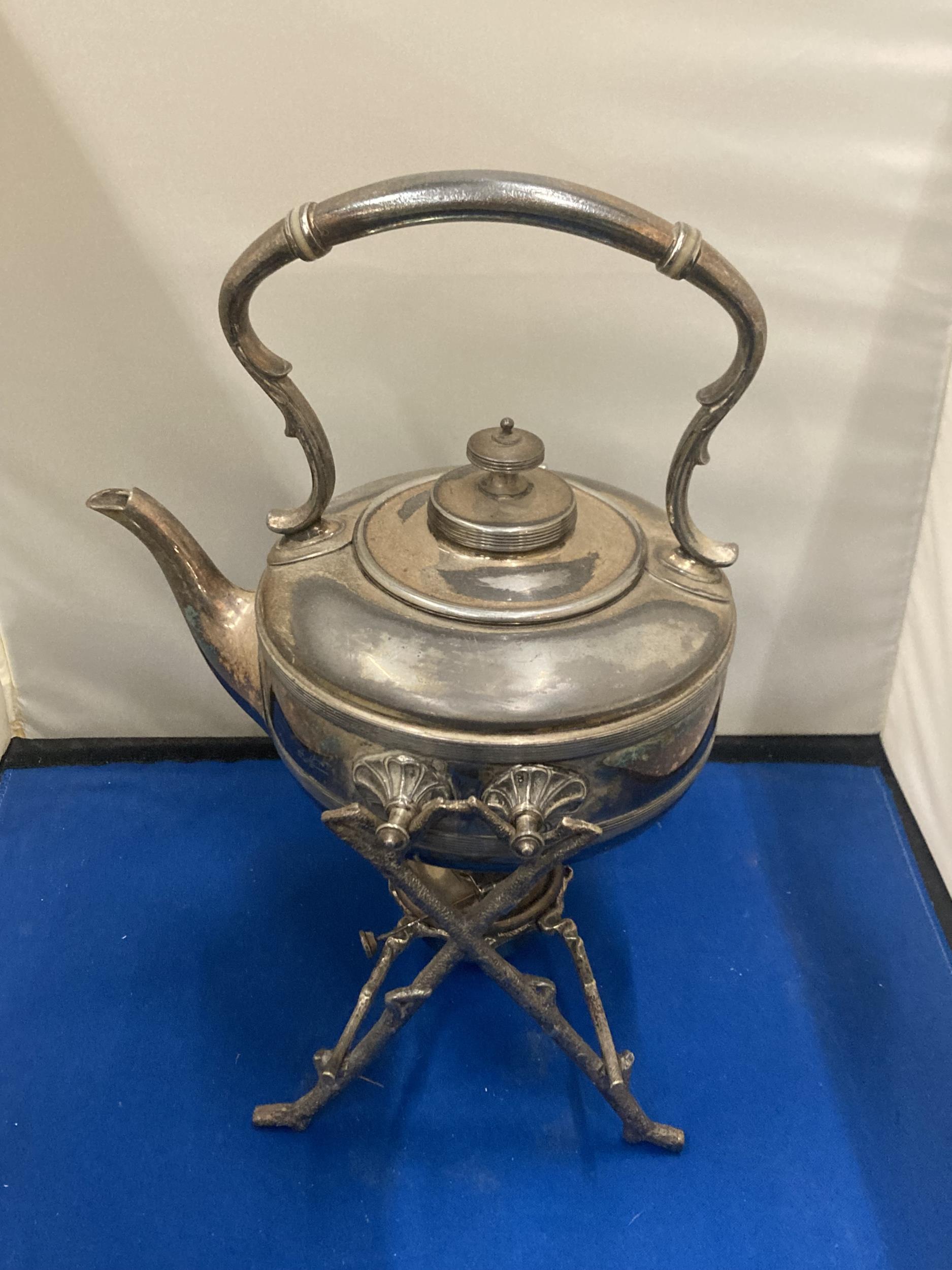 A SILVER PLATED SPIRIT KETTLE WITH FRAME AND BURNER
