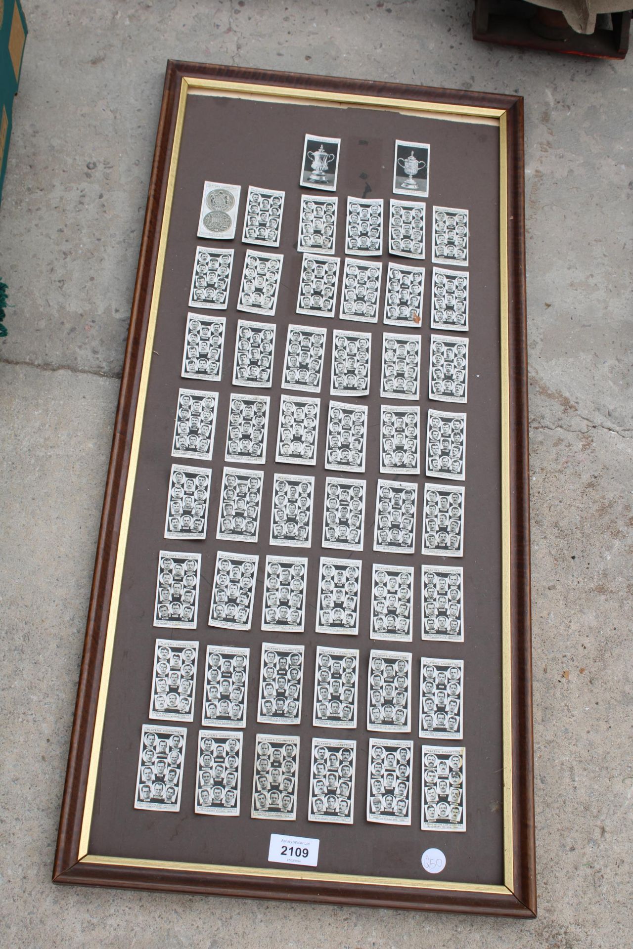 A FRAMED BOARD WITH PLAYERS CIGARETTE CARDS