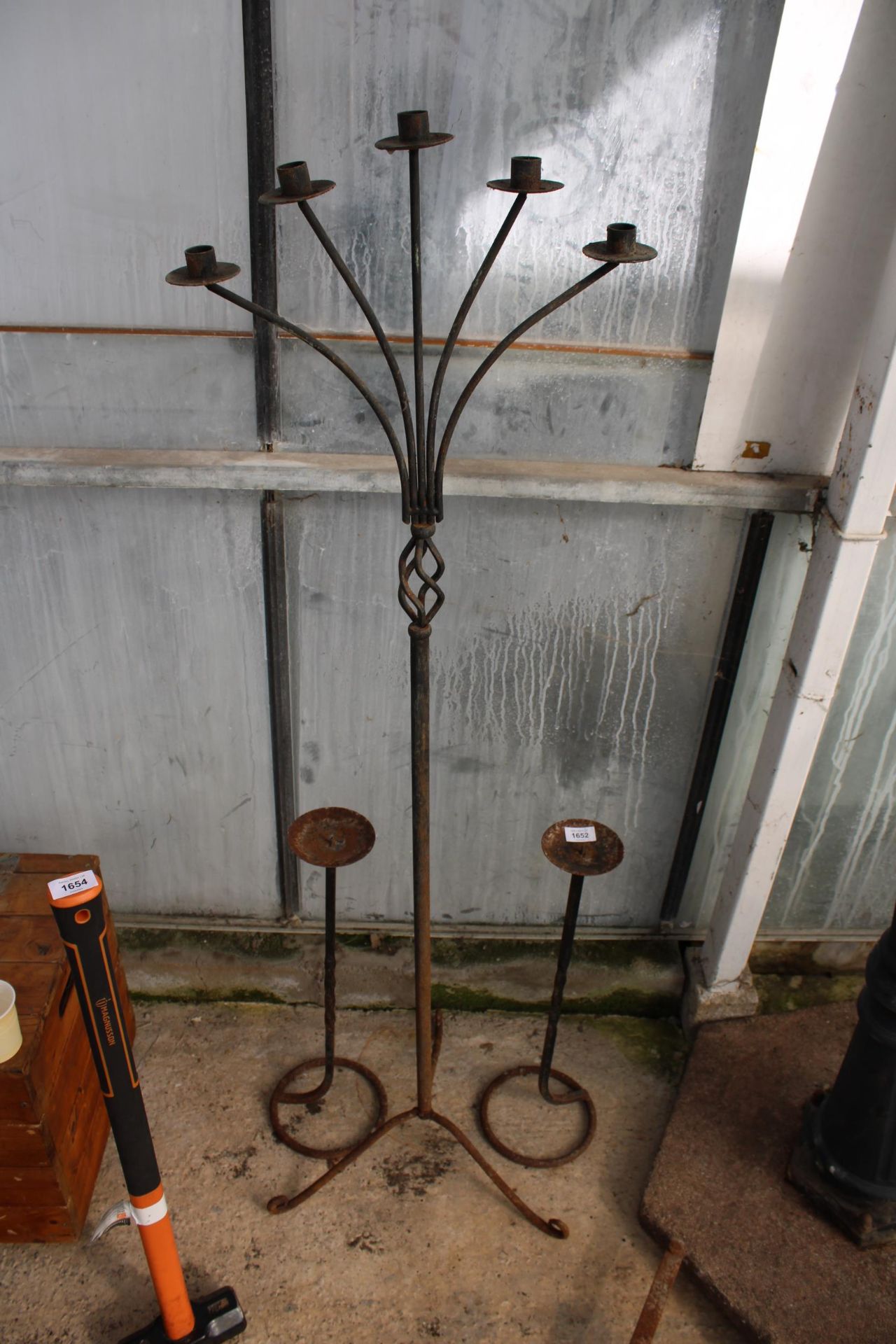 A PAIR OF METAL CANDLESTICKS AND A FURTHER 5 BRANCH METAL CANDLESTICK