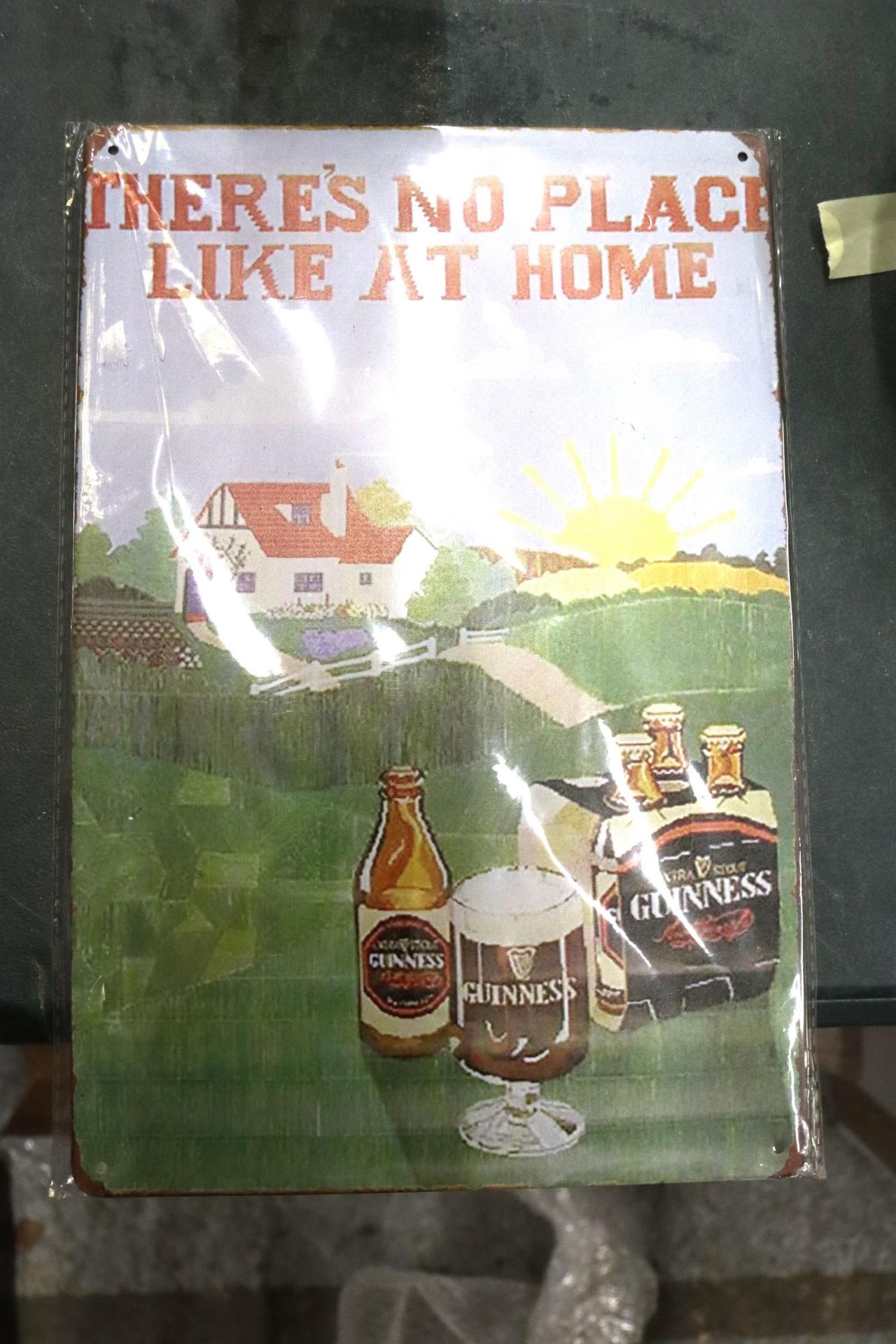 A MAN CAVE METAL SIGN, 'THERE'S NO PLACE LIKE AT HOME'