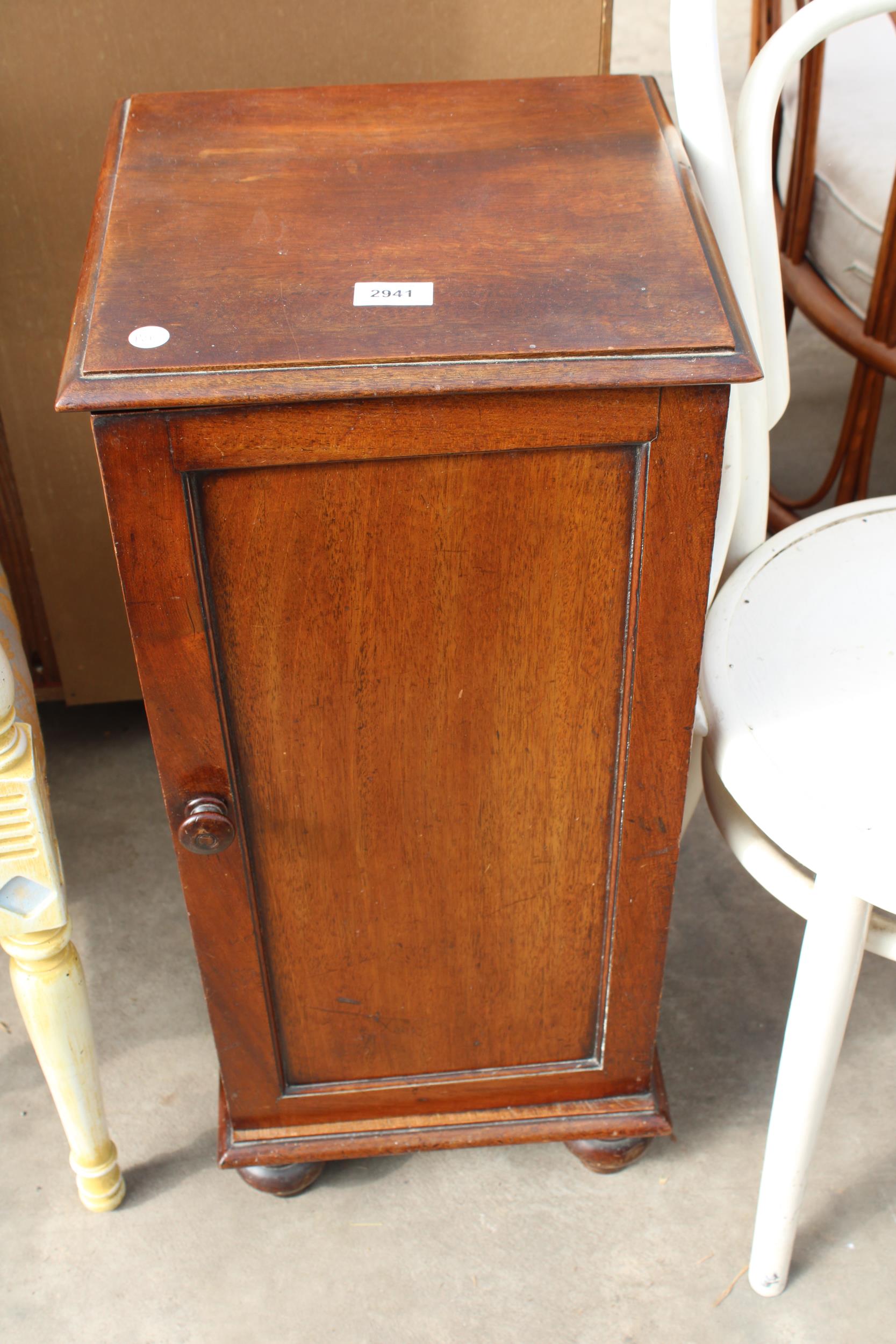 A VICTORIAN MAHOGANY POT CUPBOARD ON TURNED LEGS