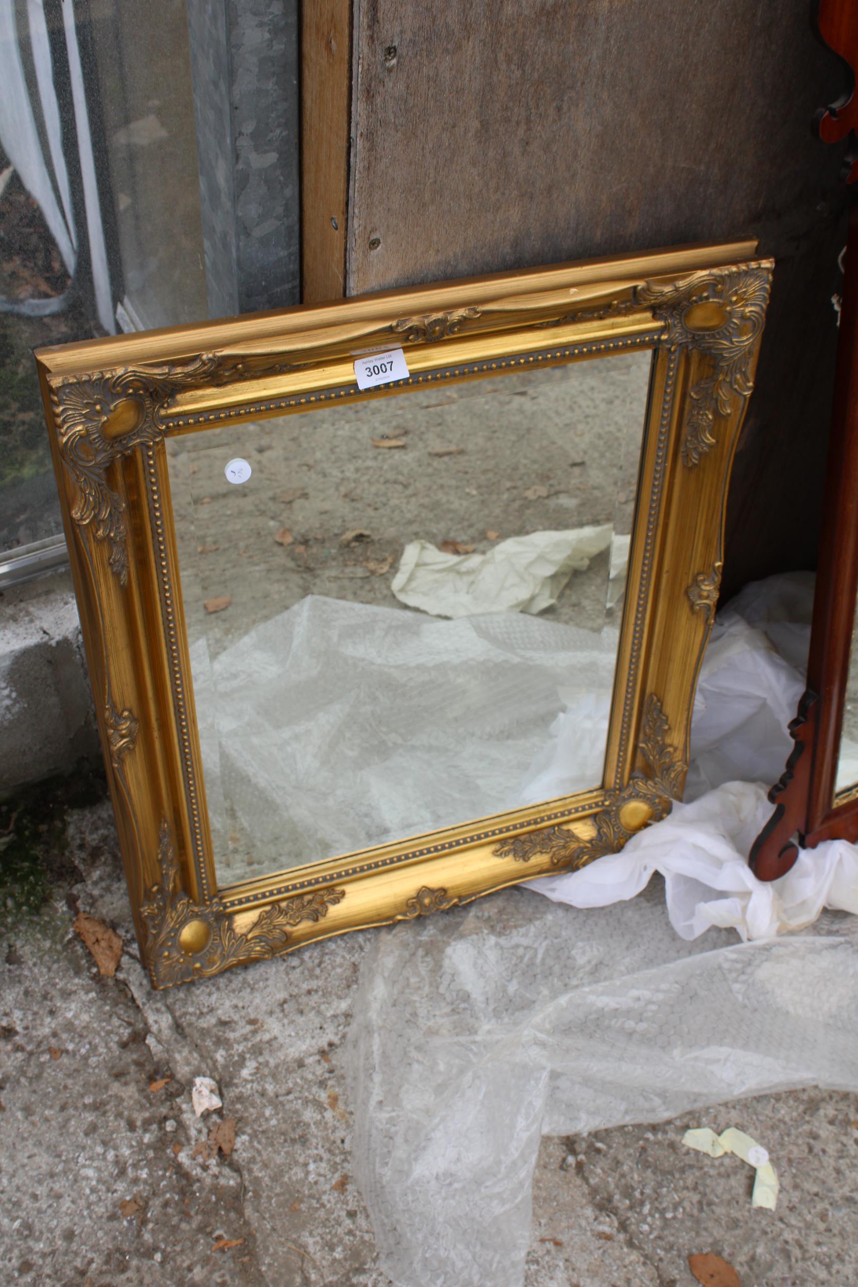 A GILT FRAMED BEVEL EDGED WALL MIRROR 26" X 21"