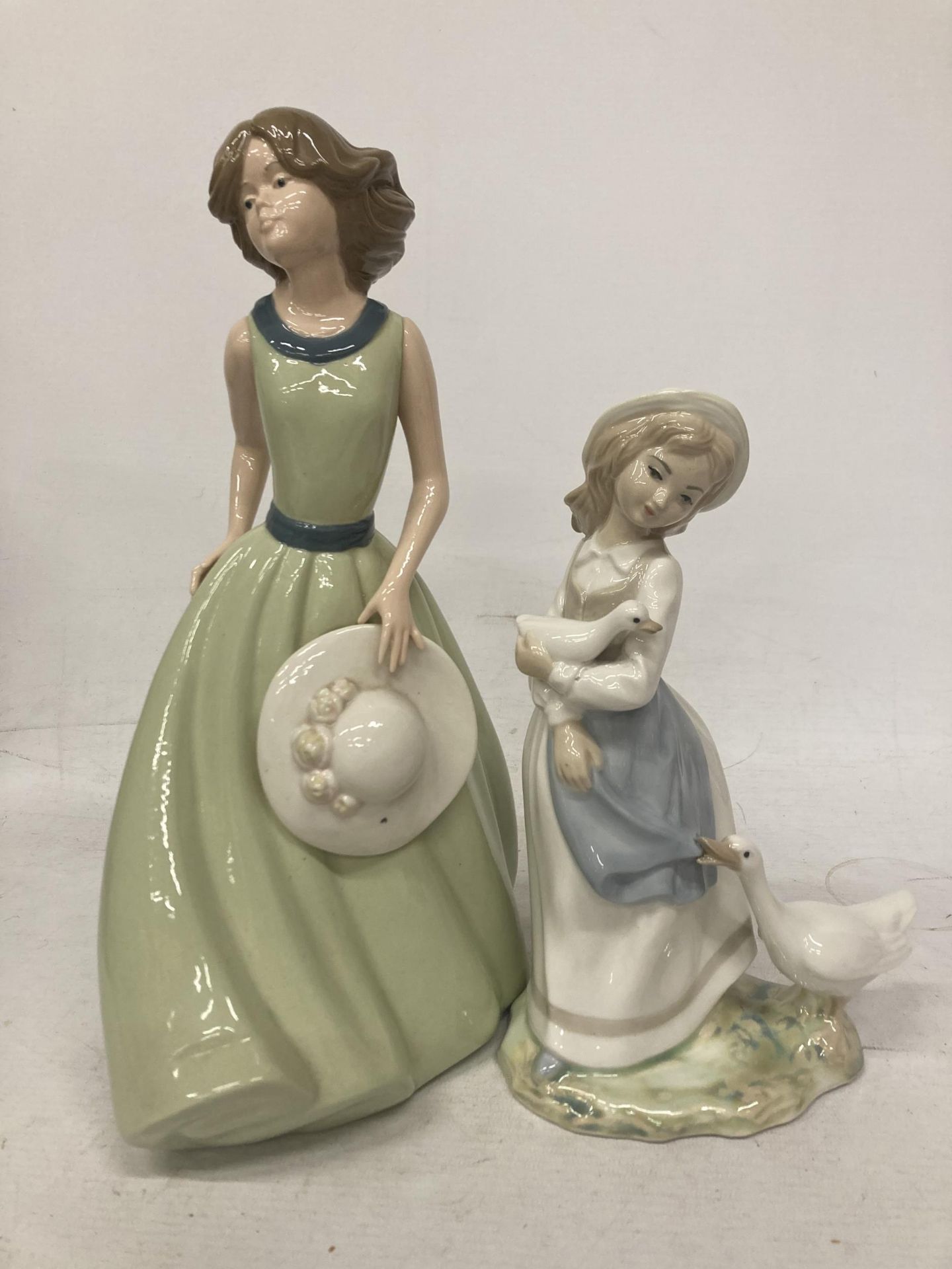 TWO SPANISH LADY FIGURES - TENGRA A GIRL WITH GEESE AND A NADEL FIGURE GIRL HOLDING A HAT