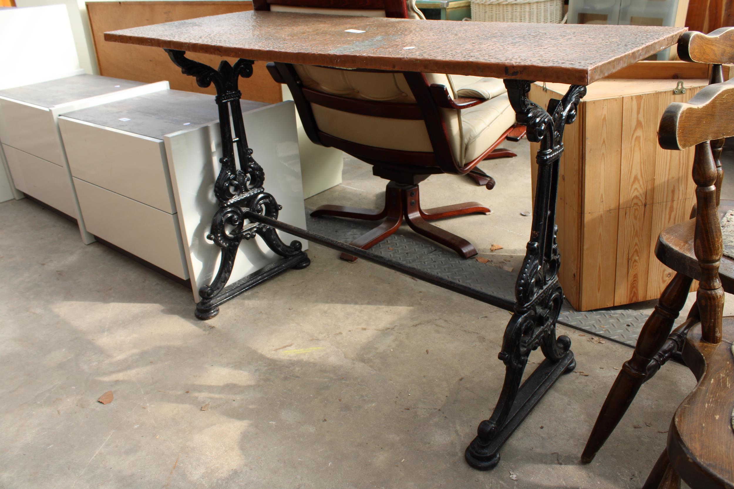 A PUB TABLE WITH AN EMBOSSED COPPER TOP 45" X 18" ON A CAST IRON BASE - Image 2 of 2