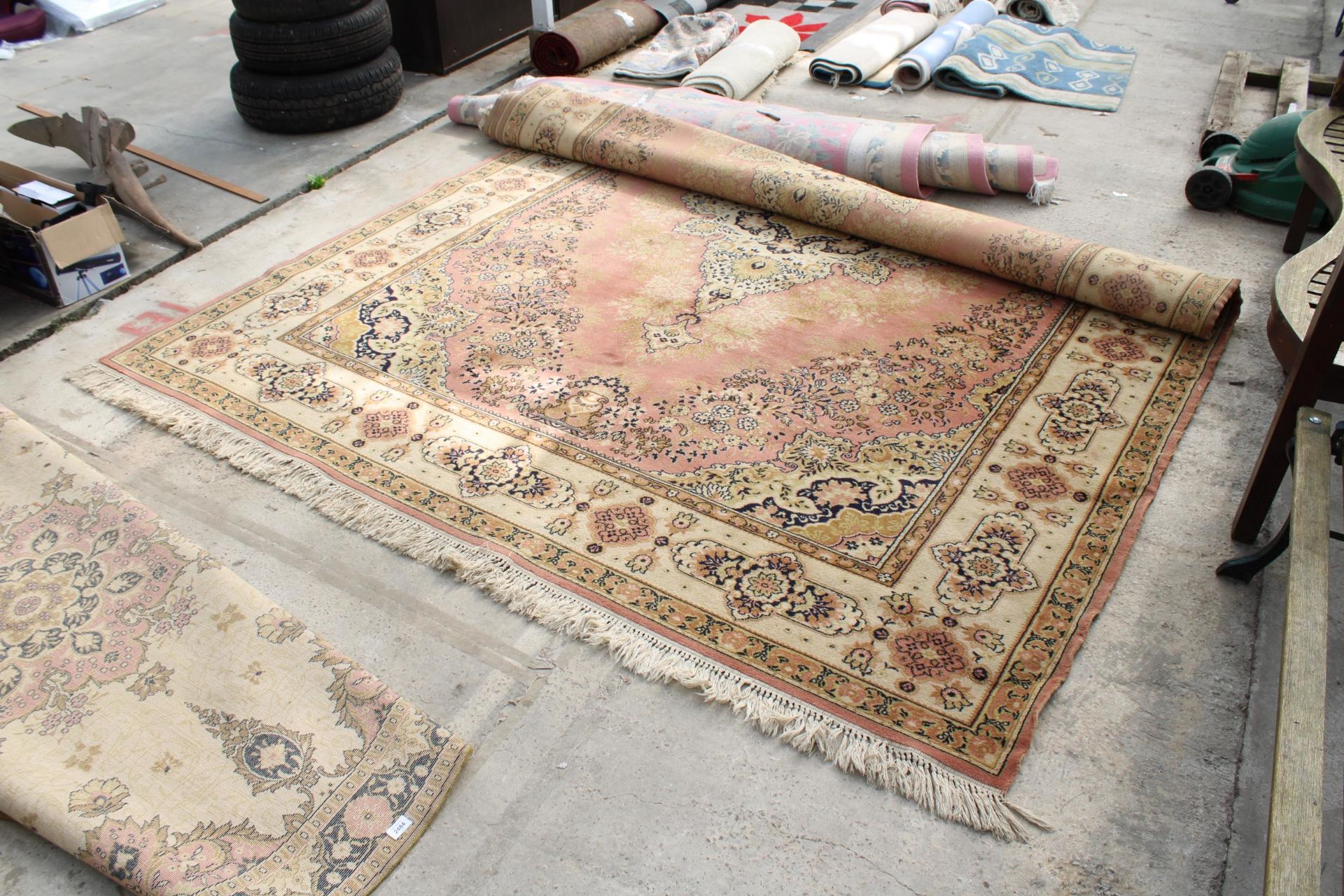 A YELLOW PATTERNED FRINGED RUG