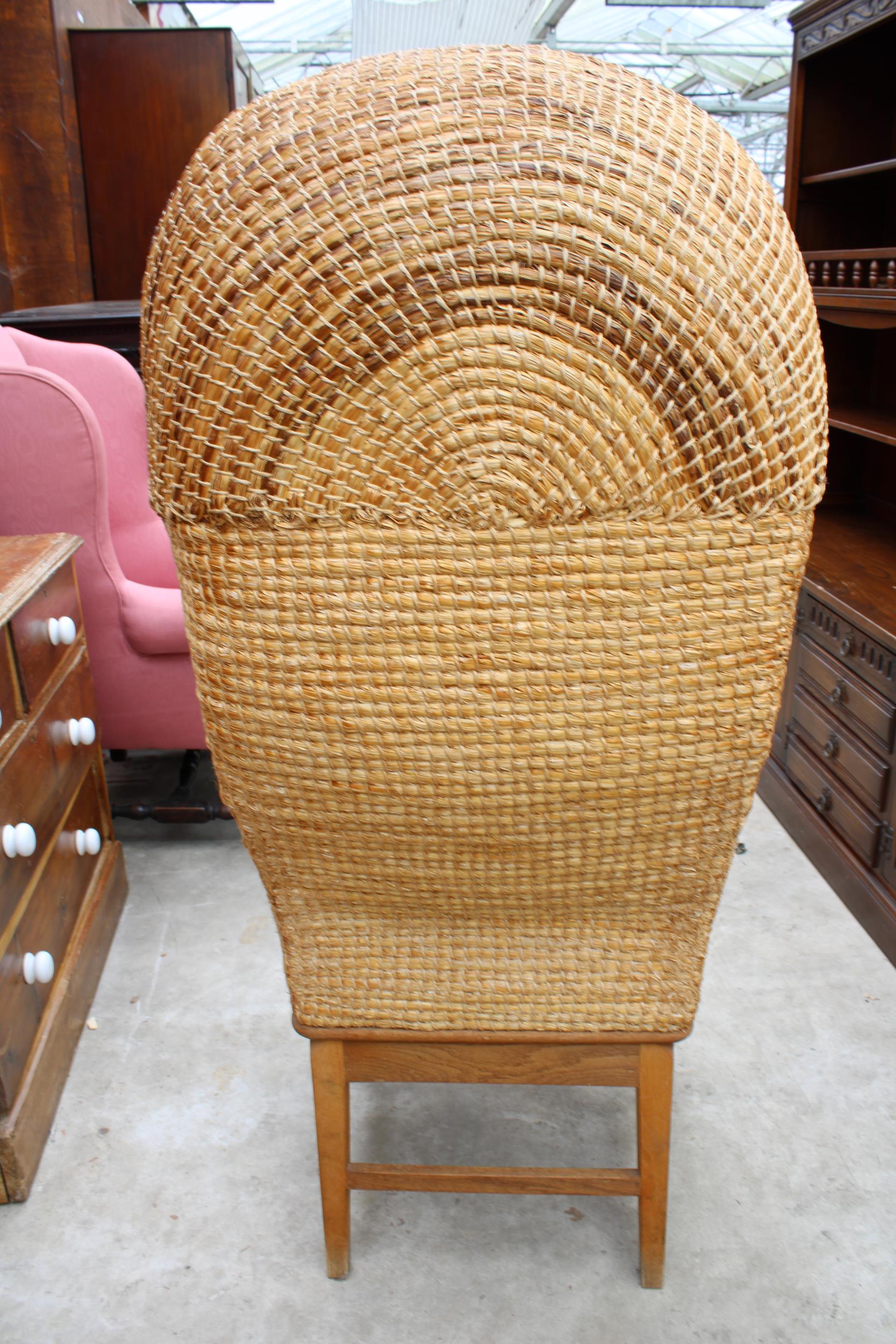 A HOODED OAK FRAMED ORKNEY CHAIR WITH WICKER SEAT AND STITCHED STRAW BACK, STAMPED D M KIRKNESS, - Image 3 of 4