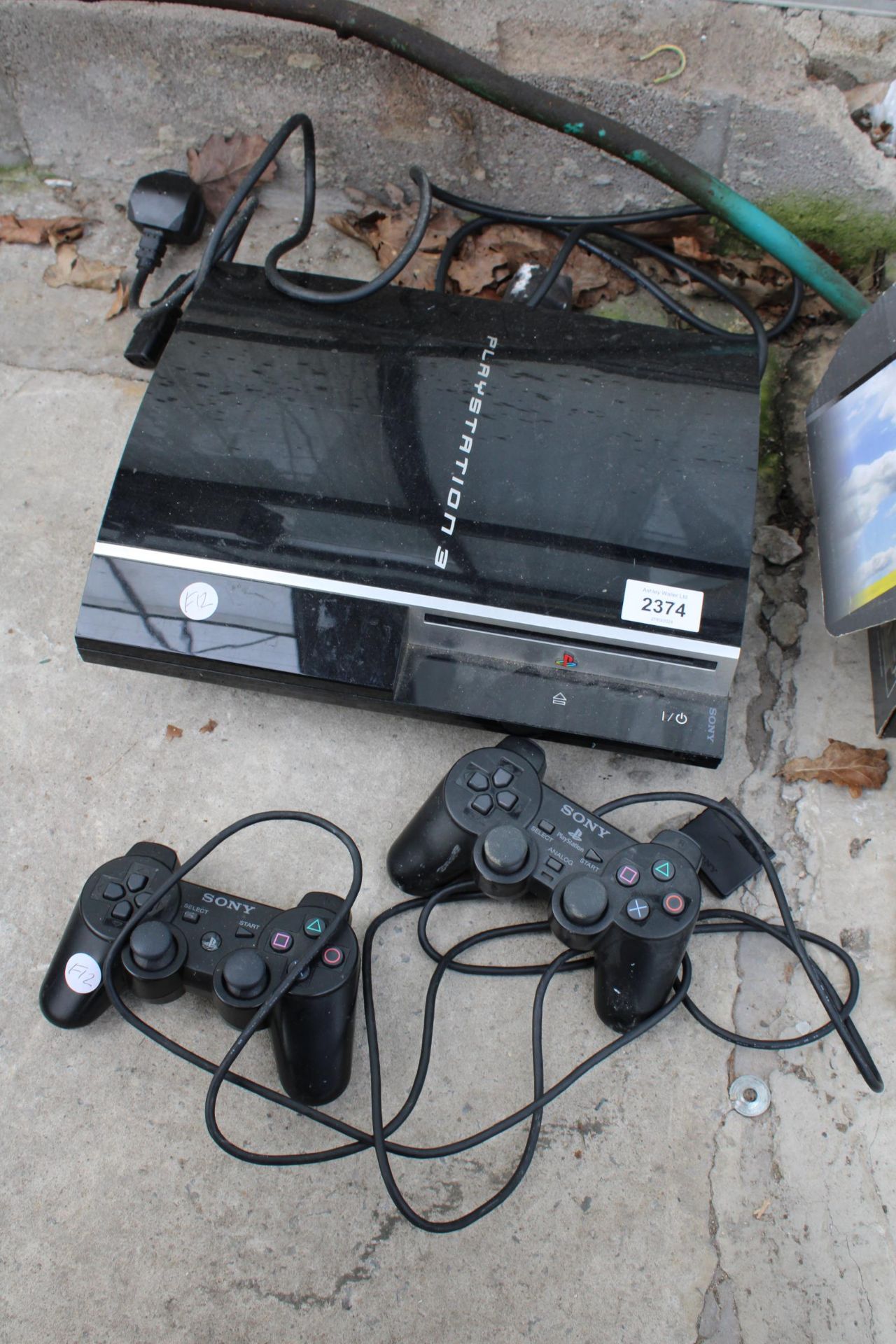 A SONY PLAYSTATION THREE AND TWO CONTROLLERS