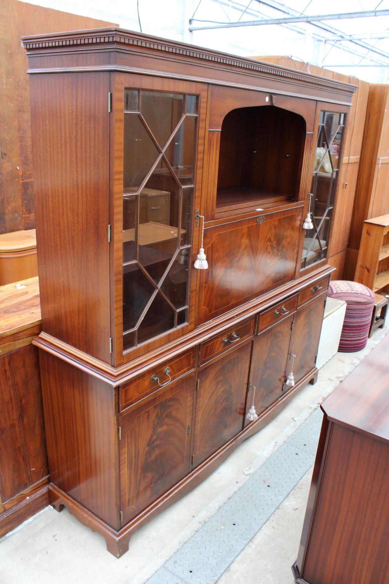 REPRODUCTION MAHOGANY AND CROSSBANDED BOOKCASE / BUREAU ON BASE 70" WIDE