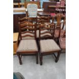 A SET OF FOUR OAK LADDER BACK DINING CHAIRS ON TURNED FRONT LEGS