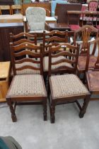 A SET OF FOUR OAK LADDER BACK DINING CHAIRS ON TURNED FRONT LEGS