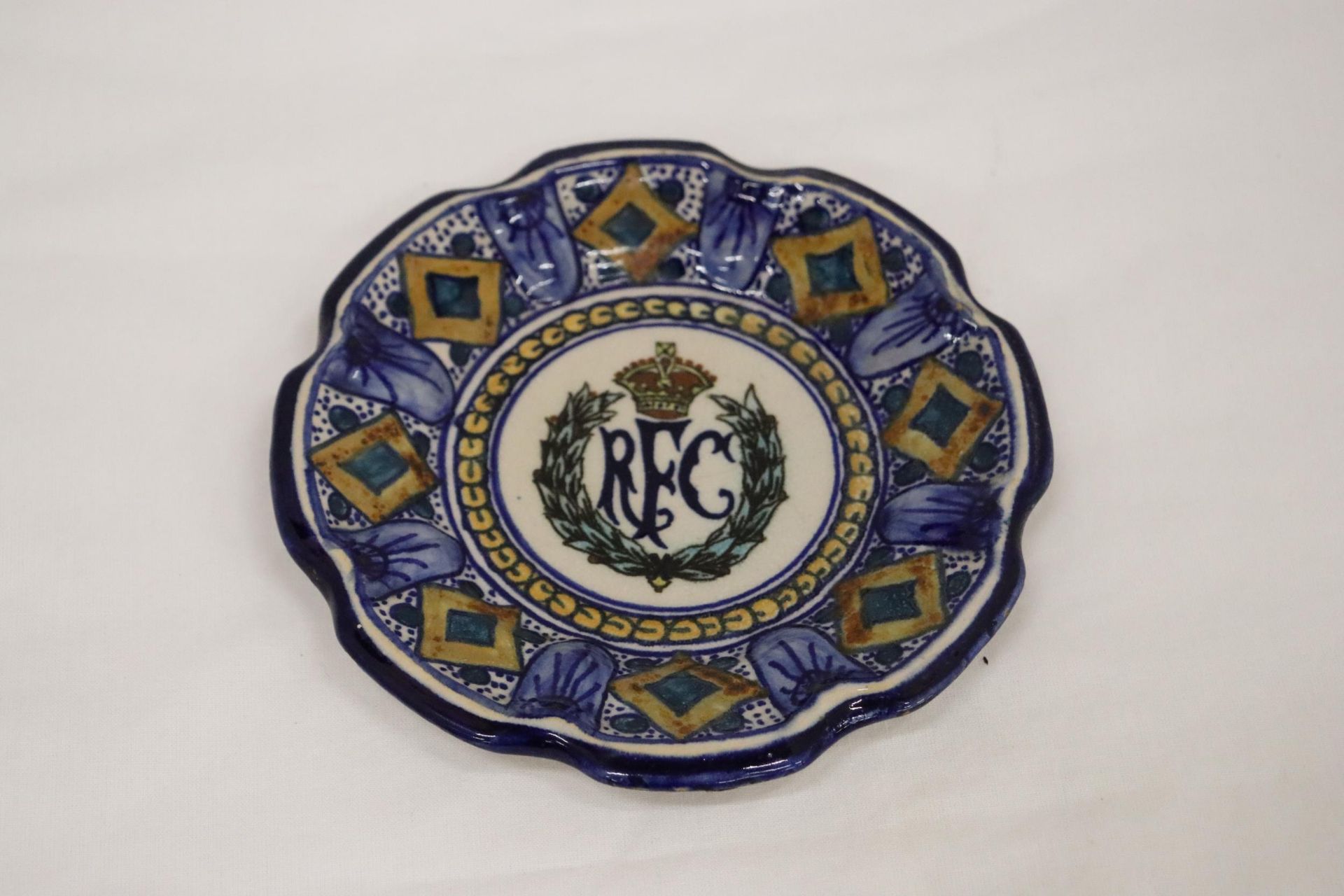 A VINTAGE CONTINENTAL SMALL PLATE WITH THE LOGO FOR THE ROYAL FLYING CORPS