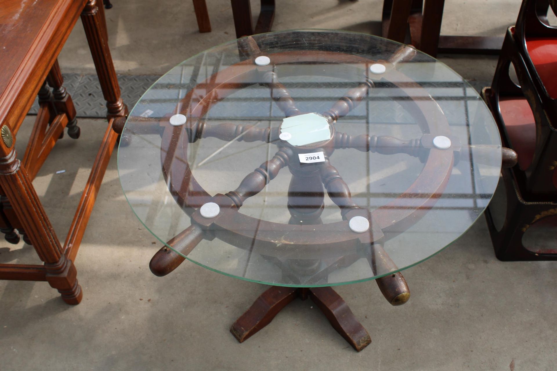 A COFFEE TABLE 24" DIAMETER THE BASE IN THE FORM OF A SHIPS WHEEL