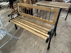 A WOODEN SLATTED GARDEN BENCH WITH CAST BENCH ENDS