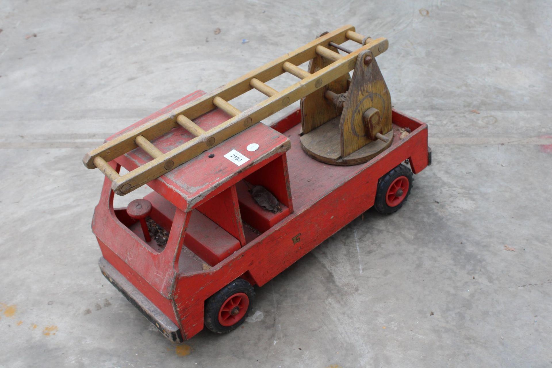 A LARGE WOODEN FIRE TRUCK