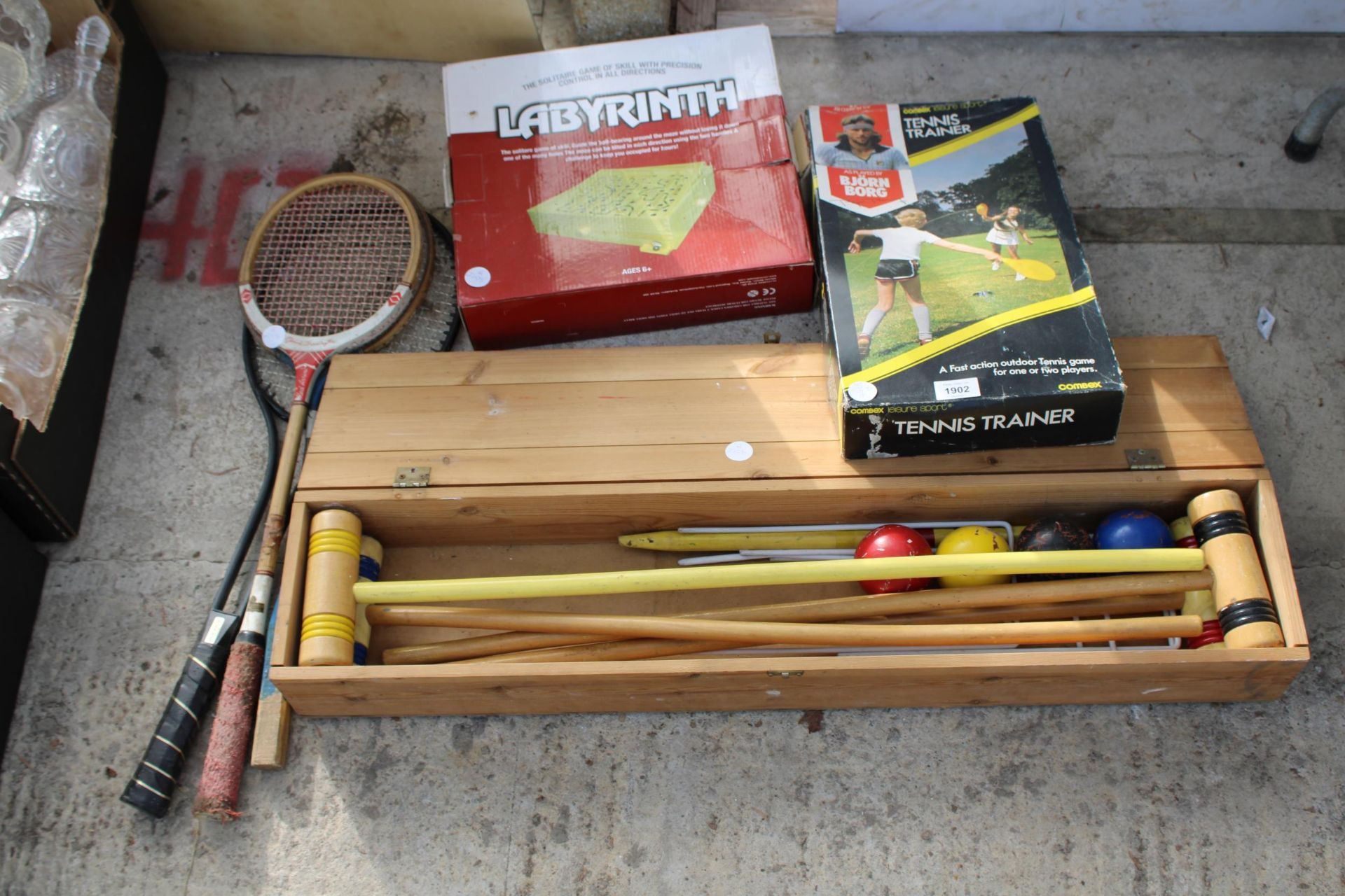AN ASSORTMENT OF GAMES TO INCLUDE LABYRINTH, TENNIS RACKETS AND A CROQUET SET ETC