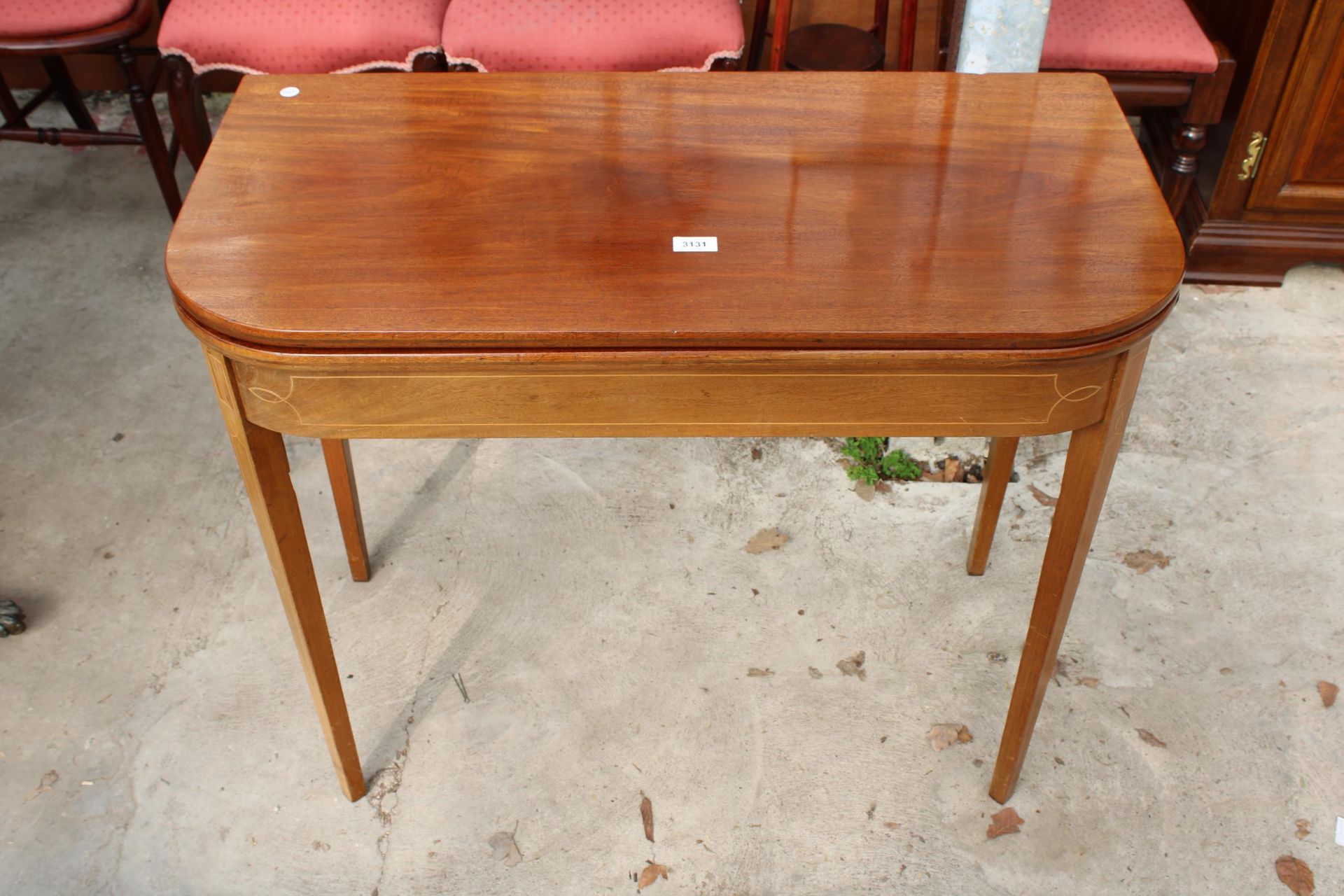 A 19TH CENTURY MAHOGANY AND INLAID FOLD OVER TEA TABLE