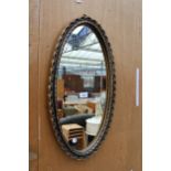 A GILT EFFECT OVAL WALL MIRROR 24" x 13"