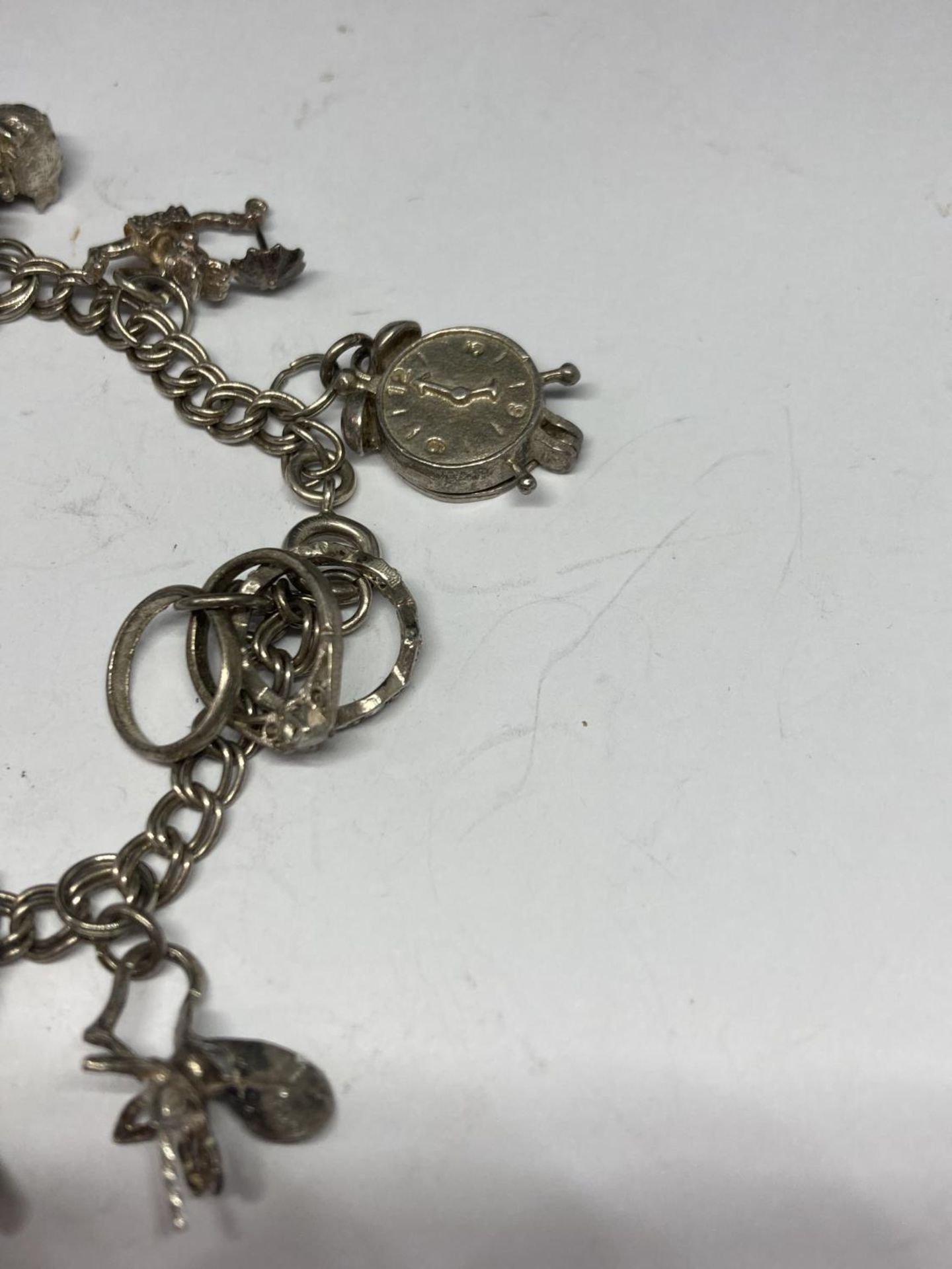 A SILVER CHARM BRACELET WITH TEN CHARMS - Image 2 of 4
