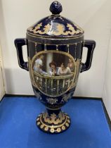 A ROYAL LIMOGES TWIN HANDLED VASE IN BLUE AND GOLD WITH LADIES ON A BALCONY DECORATION HEIGHT 35CM