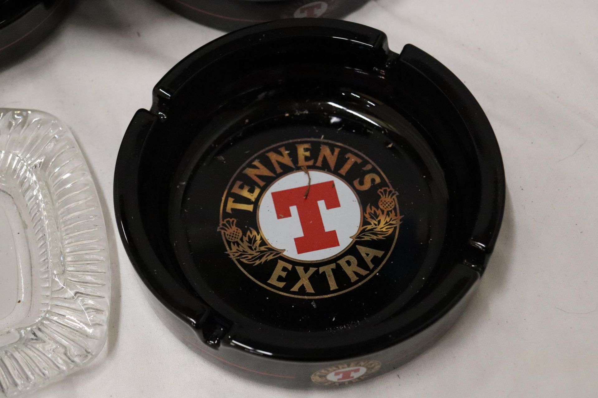 FIVE GLASS PUN ASHTRAYS TO INCLUDE TENNENTS EXTRA - Image 3 of 6