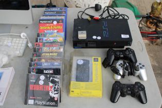 A PLAYSTATION 2, AN ASSORTMENT OF PLAYSTATION AND PS2 GAMES AND THREE PS2 CONTROLLERS ETC