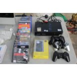 A PLAYSTATION 2, AN ASSORTMENT OF PLAYSTATION AND PS2 GAMES AND THREE PS2 CONTROLLERS ETC