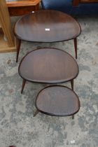 AN ERCOL NEST OF THREE PEBBLE TABLES