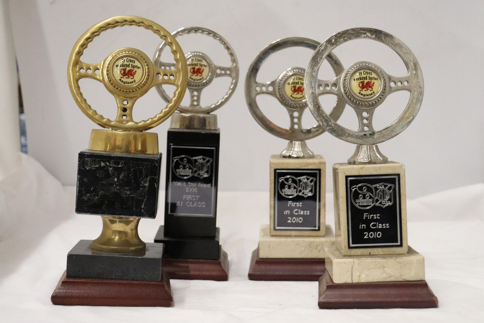 FOUR QUALITY BRASS AND STEEL ANGLESEY CAR CLUB AWARDS