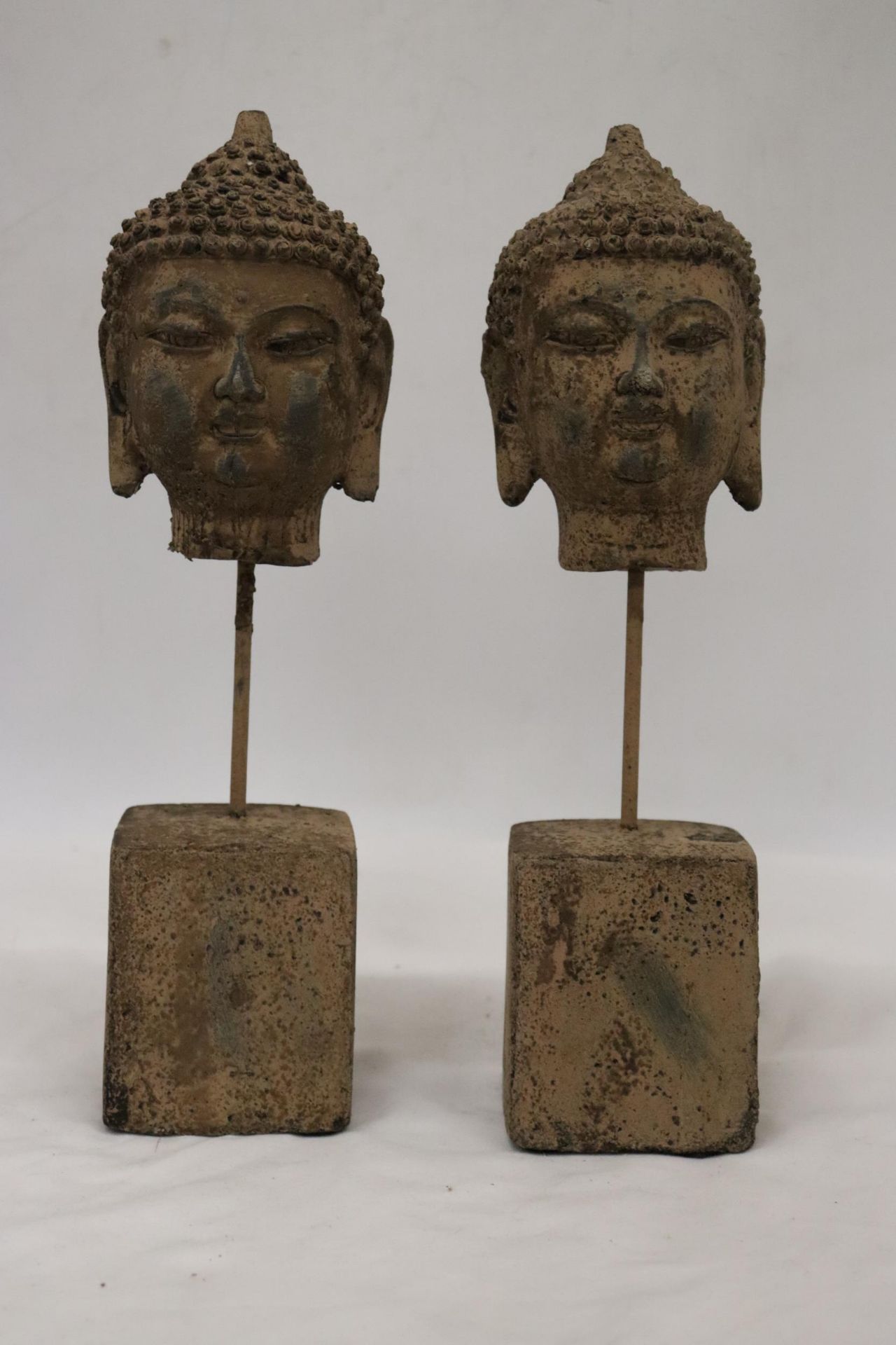 TWO BUDDAH HEADS ON STANDS