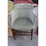AN EDWARDIAN TUB CHAIR WITH UPHOLSTERED UPPER SECTION ON TURNED ELM BASE