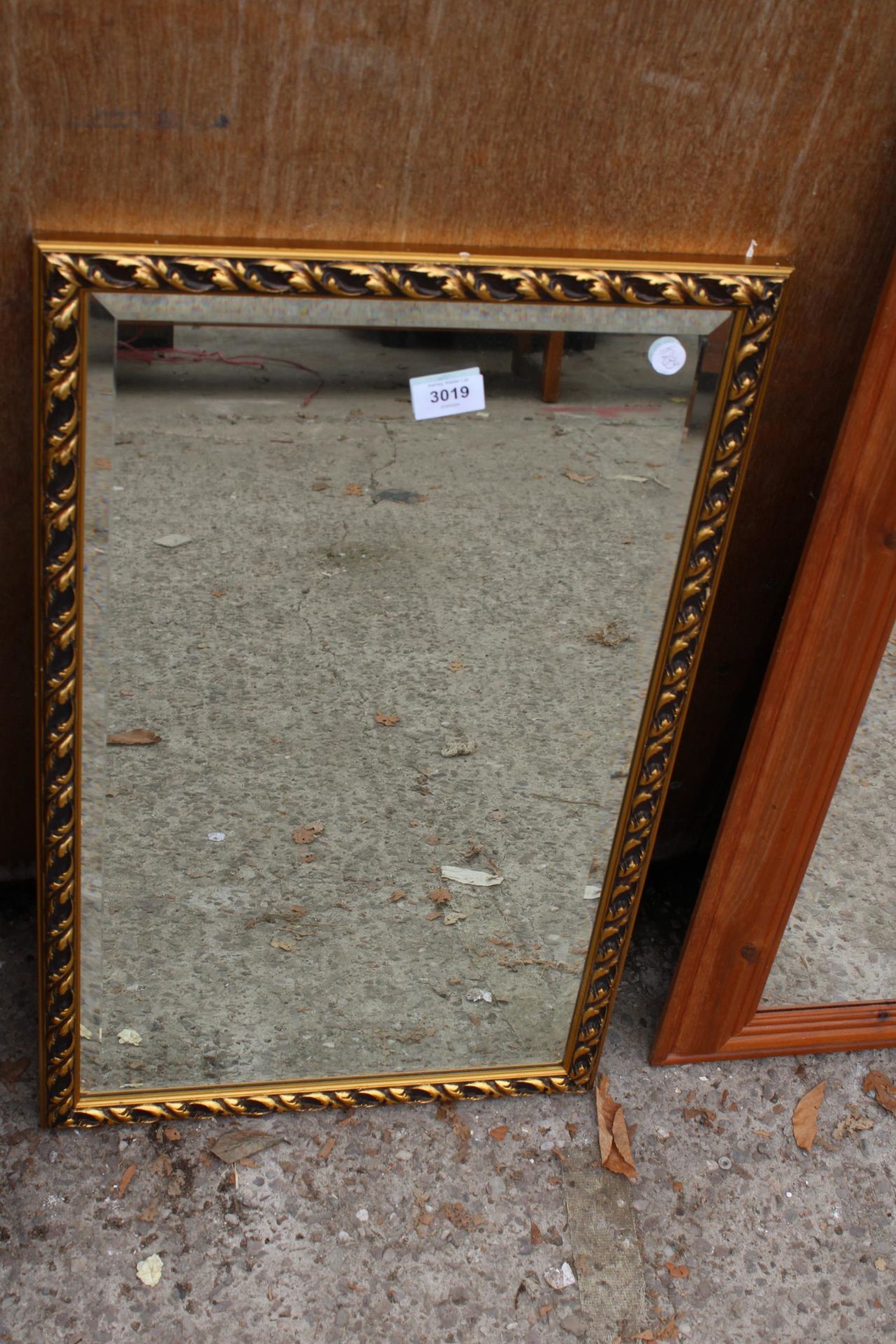 A GILT FRAMED BEVEL EDGE WALL MIRROR 26" x 16"