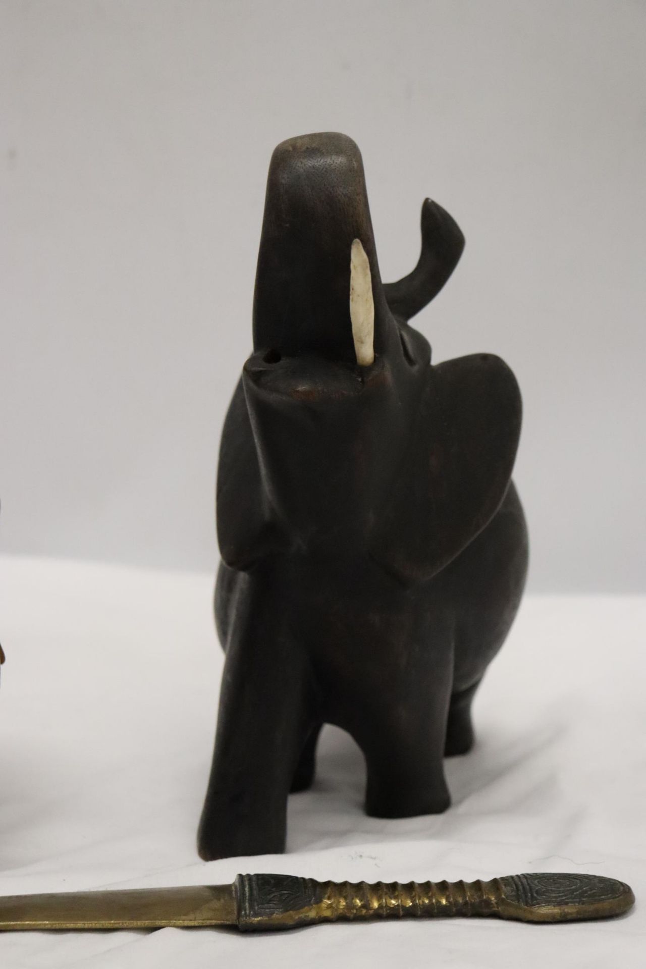 A HARDWOOD CARVED ELEPHANT, STONE ELEPHANT, MISSING A LEG AND A BRASS KNIFE - Image 3 of 12