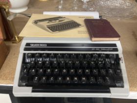A SILVER-REED SR 100 "EROS" TYPEWRITER WITH OPERATING INSTRUCTION MANUAL PLUS PTMAN'S COMMERCIAL