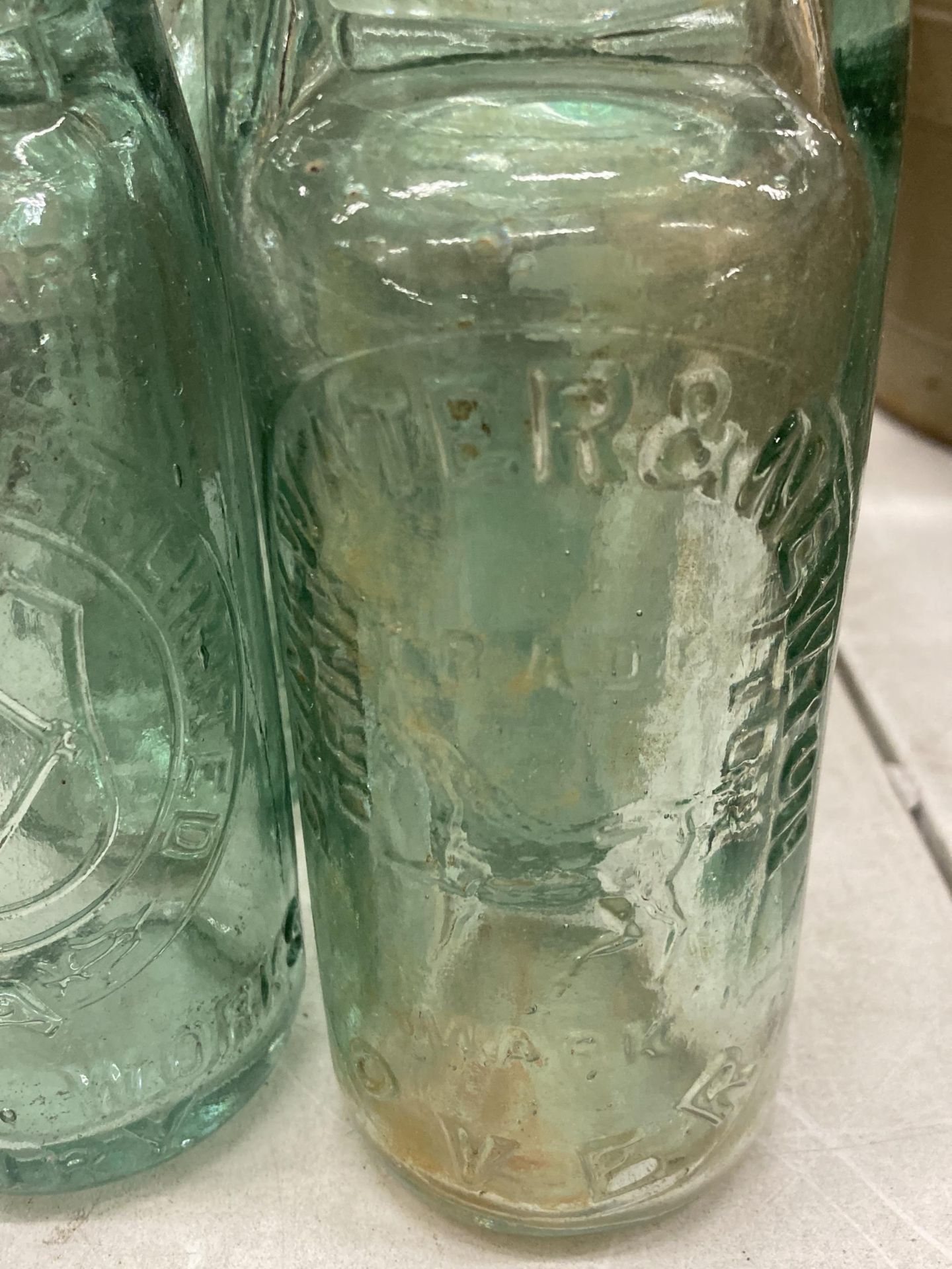 EIGHT GLASS CODD BOTTLES, WITH ADVERTISING TO THE FRONT AND GLASS MARBLE STOPPERS - Image 3 of 3
