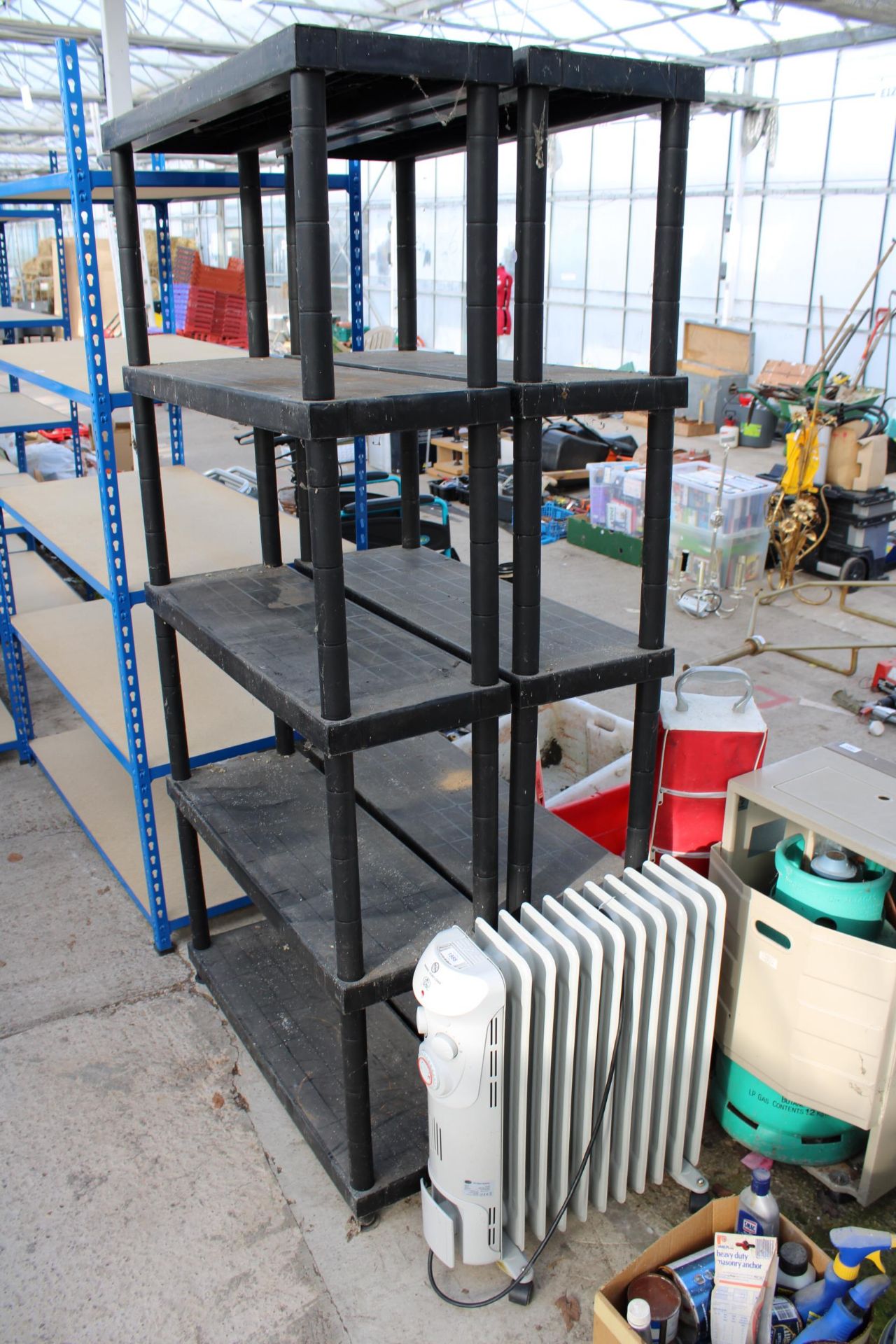 AN ELECTRIC HEATER AND TWO PLASTIC SHELVING UNITS