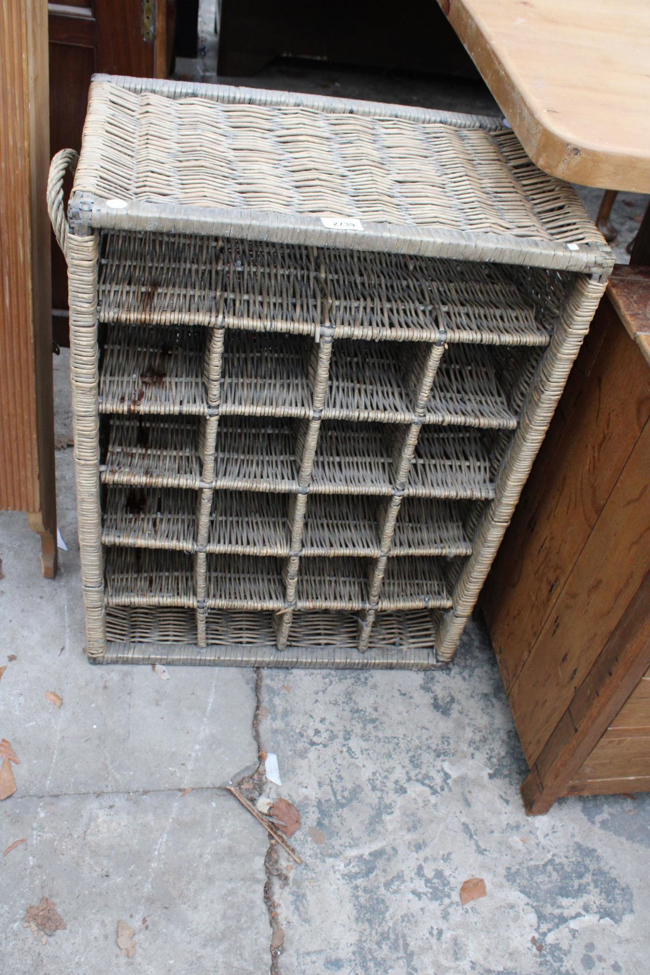 A RATTAN TWENTY BOTTLE WINE RACK