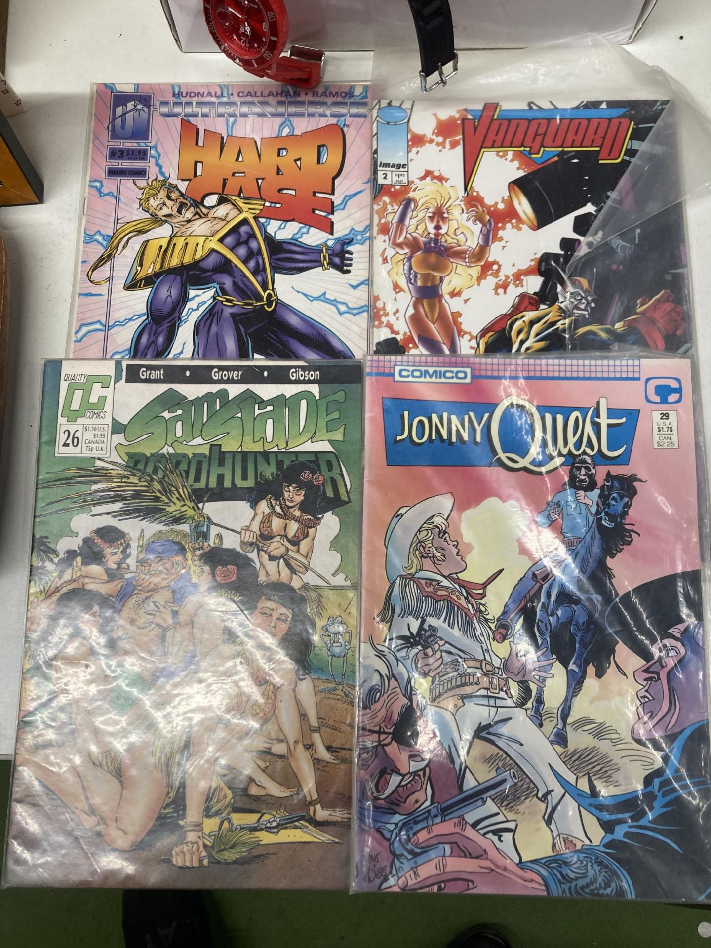 A COLLECTION OF FOUR VINTAGE COMICS TO INCLUDE SAMSLADE, JONNY QUEST,HARD CASE AND VANGUARD