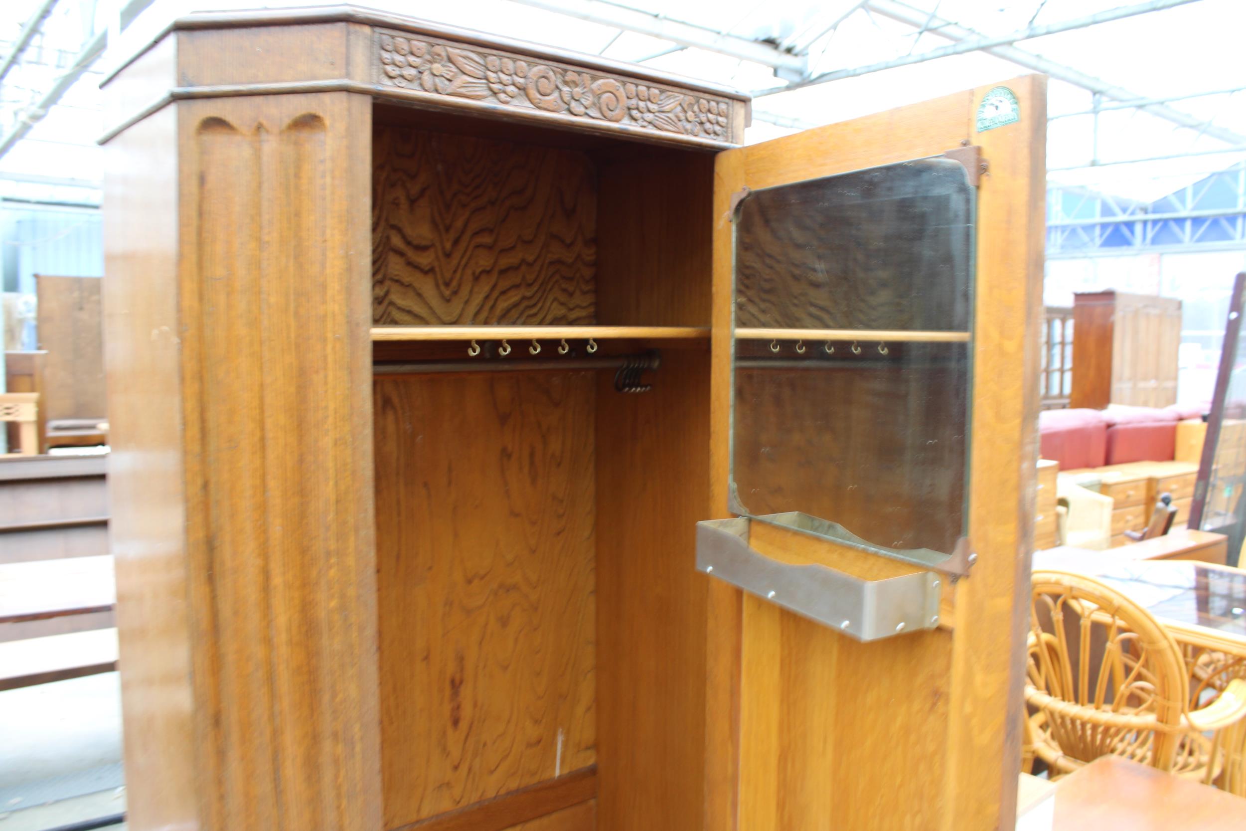 AN EARLY 20TH CENTURY OAK HALL WARDROBE WITH CARVED PANEL DOOR 30" WIDE - Image 2 of 2