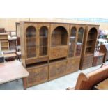 A RANGE OF FOUR 'AUSTINSUITE' BURR WALNUT EFFECT LOUNGE UNITS, EACH UNIT 29" WIDE