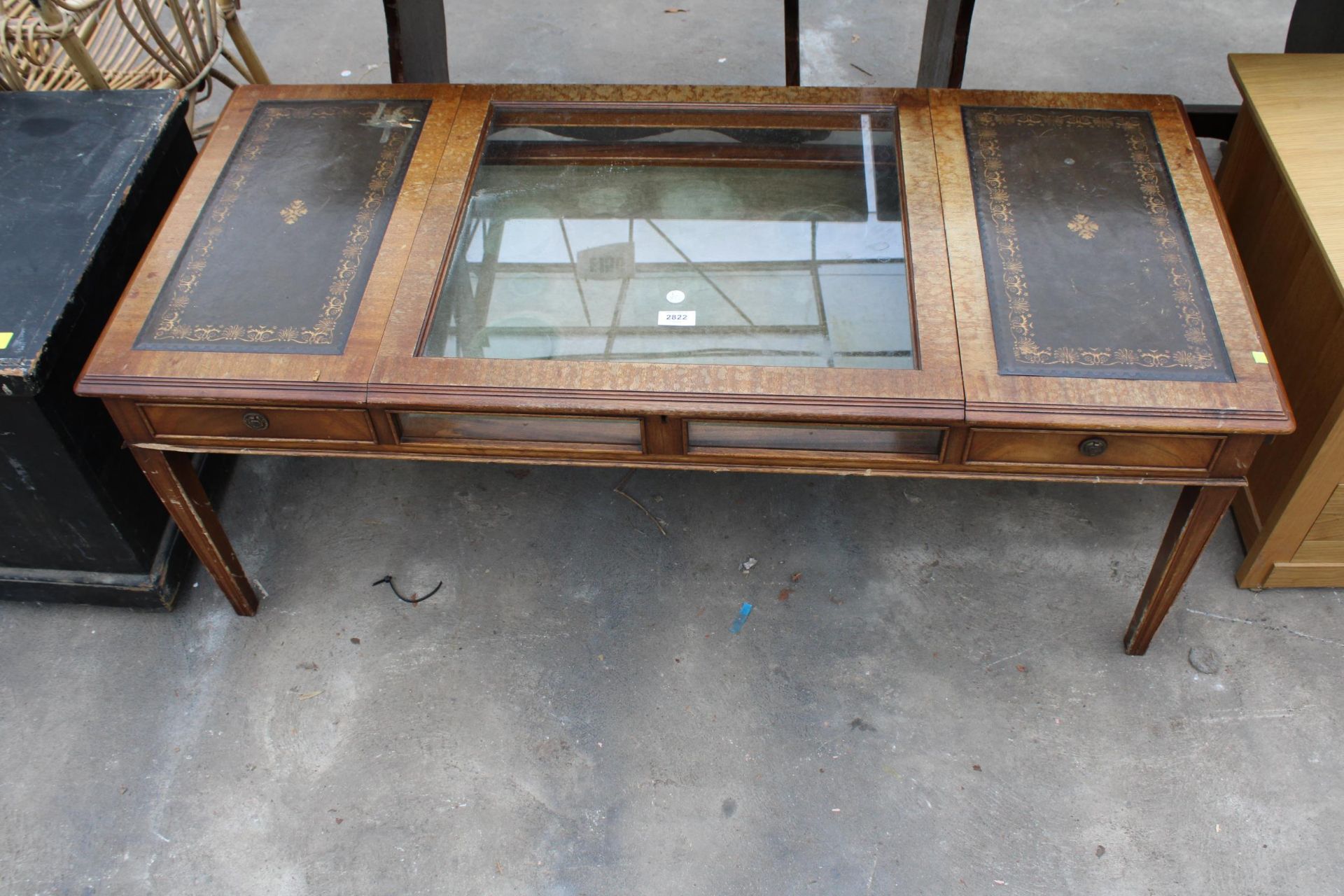 A MAHOGANY COFFEE/BIJOUTERIE TABLE WITH INSET LEATHER TOP AND TWO END DRAWERS 49" X 22"