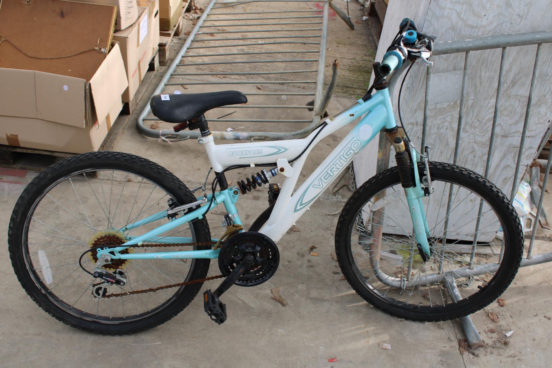 A ROCKFACE CHILDS MOUNTAIN BIKE WITH FRONT AND REAR SUSPENSION AND 18 SPEED SHIMANO GEAR SYSTEMS