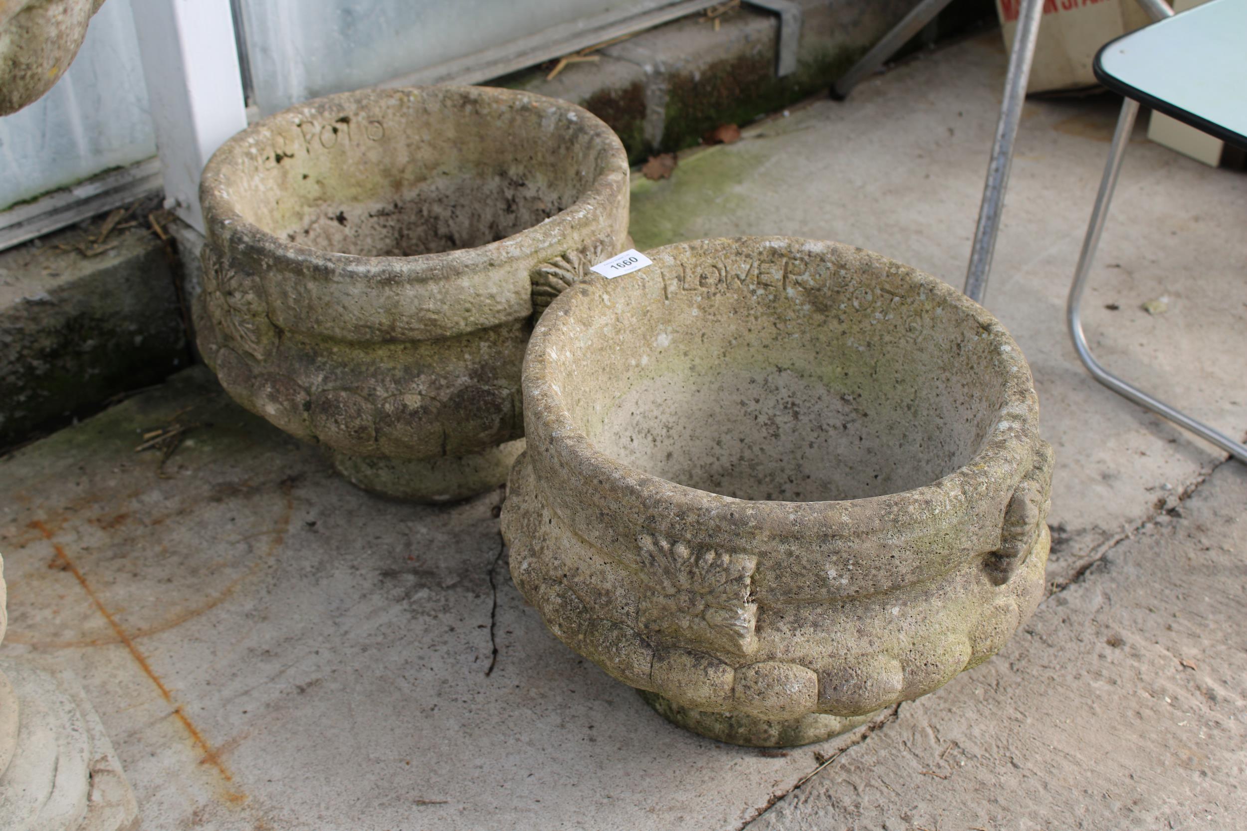 A PAIR OF DECORATIVE CONCRETE GARDEN PLANTERS