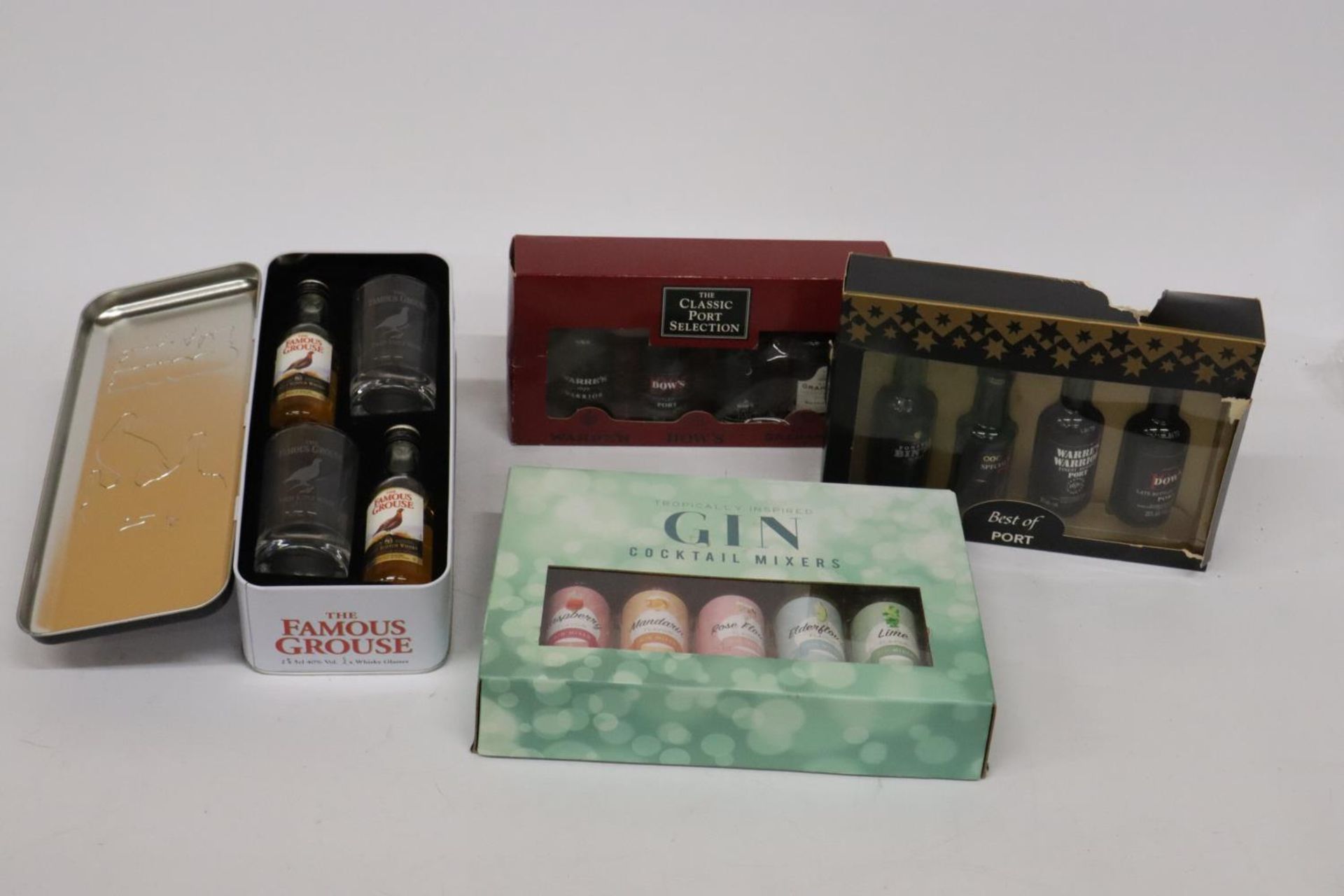 FOUR BOXES OF MINIATURE BOTTLES OF ALCOHOL TO INCLUDE FAMOUSE GROUSE WHISKEY, PORT AND TROPICAL