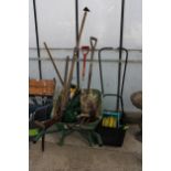 AN ASSORTMENT OF GARDEN TOOLS TO INCLUDE A HOSE PIPE, A PUSH MOWER AND A WHEEL BARROW ETC